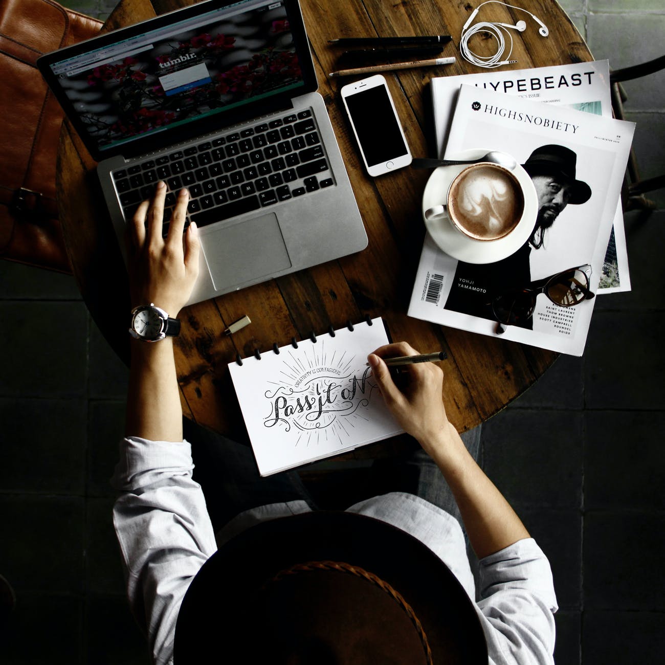 NordVPN iOS App auf Deutsch erhältlich person sitting facing laptop computer with sketch pad