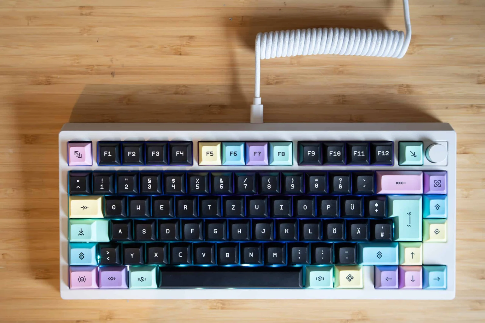 Klick, Klack, Konto leer: Mein Jahr mit mechanischen Tastaturen RGB mechanischer Tastatur mit bunten Keycaps auf Holzuntergrund.