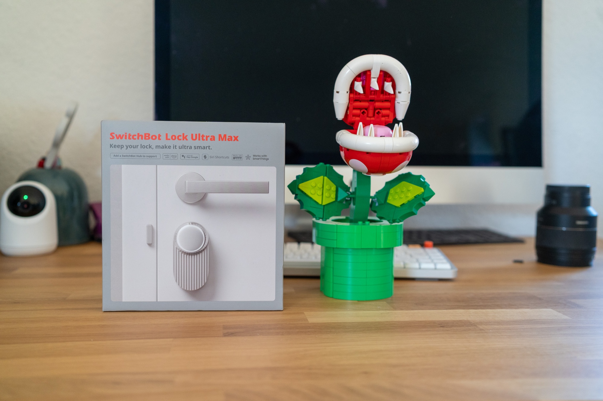 SwitchBot Lock Ultra Max Test: der Karton auf meinem Schreibtisch, daneben eine Piranha-Pflanze aus Lego